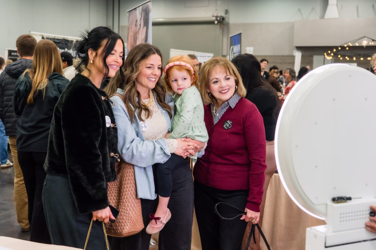 Wedding show attendees including families with children visiting exhibitor booths at The Portland Wedding Show 2026 bridal expo