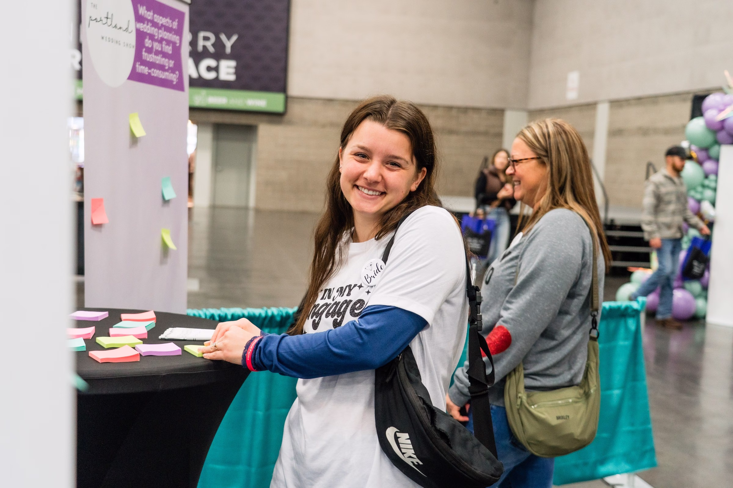 portland wedding show 2026 exhibitor booth interactive display - The Portland Wedding Show Wedding show attendees interact with colorful sticky note display at Portland Wedding Show 2026 exhibitor booth