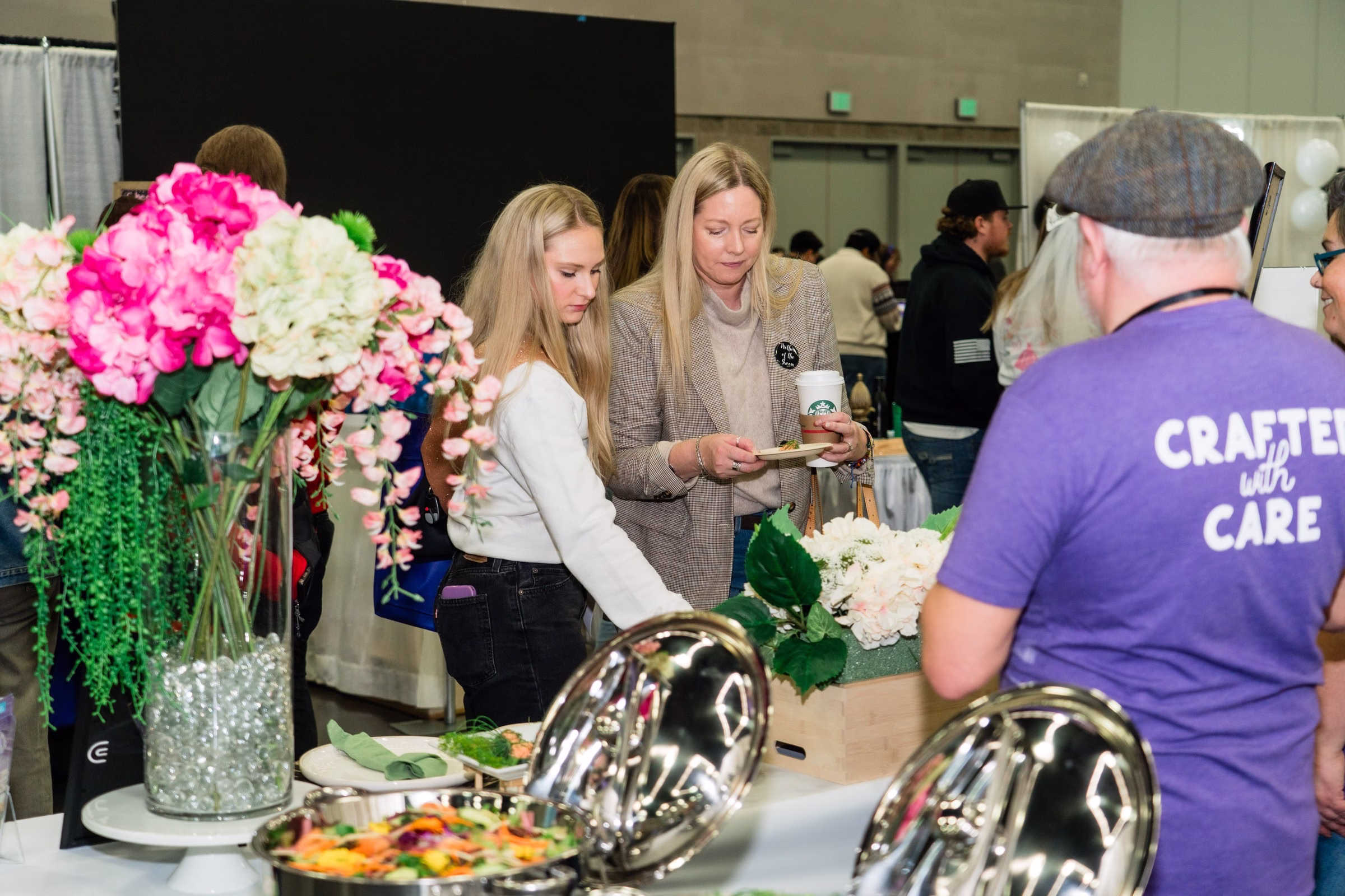 Wedding vendors showcase floral arrangements and catering displays at The Portland Wedding Show 2026 bridal expo
